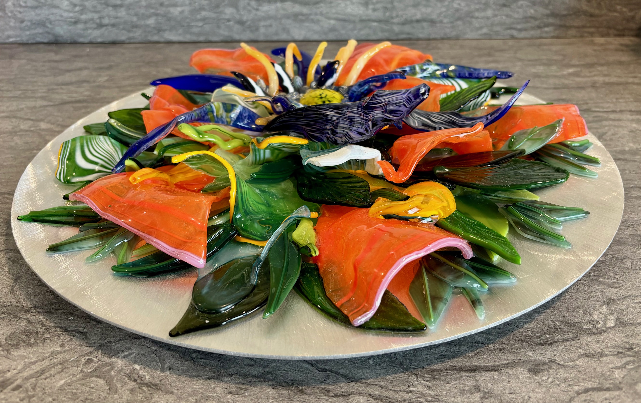 Lead image of the Bloom room: a flower platter in fused glass.