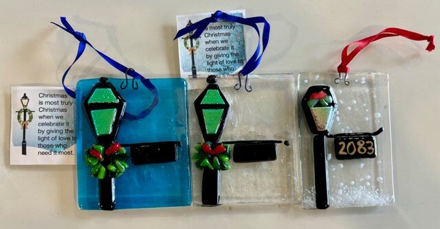 Holiday Lamp Post: fused-glass street lamp ornaments trimmed with holly, on blue, clear, and snowy white panels, one with a gold house number.