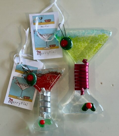 Merrytini: fused-glass martini glass ornaments in red and green, each with a glass olive topped with holly.