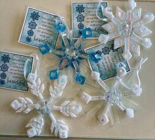 Snowflake: hand-cut fused-glass snowflake ornaments in white, blue, and iridescent glass.