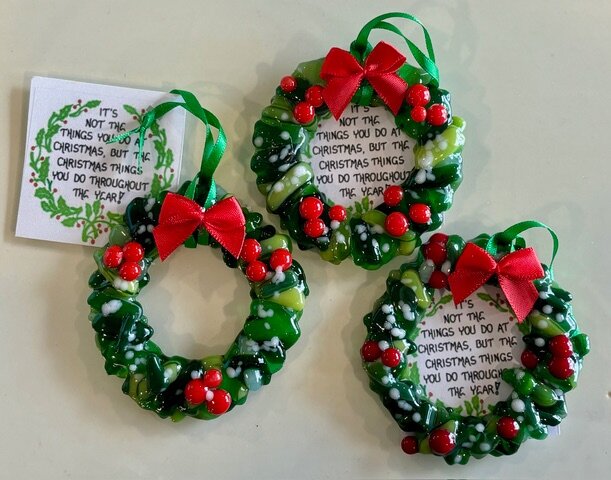 Holiday Wreath: green fused-glass wreath ornaments dotted with red berries and tied with a red bow.